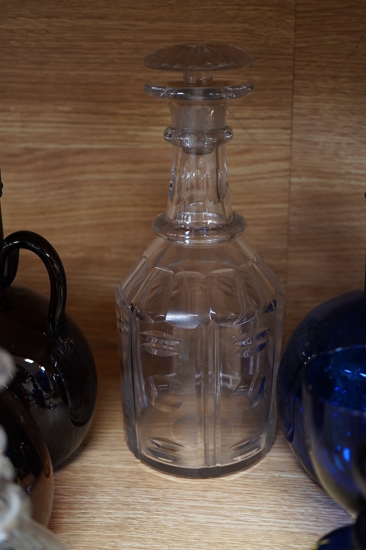 A collection of coloured glass flagons, glasses and bottles etc. (18). Tallest decanter and stopper 25cm high.